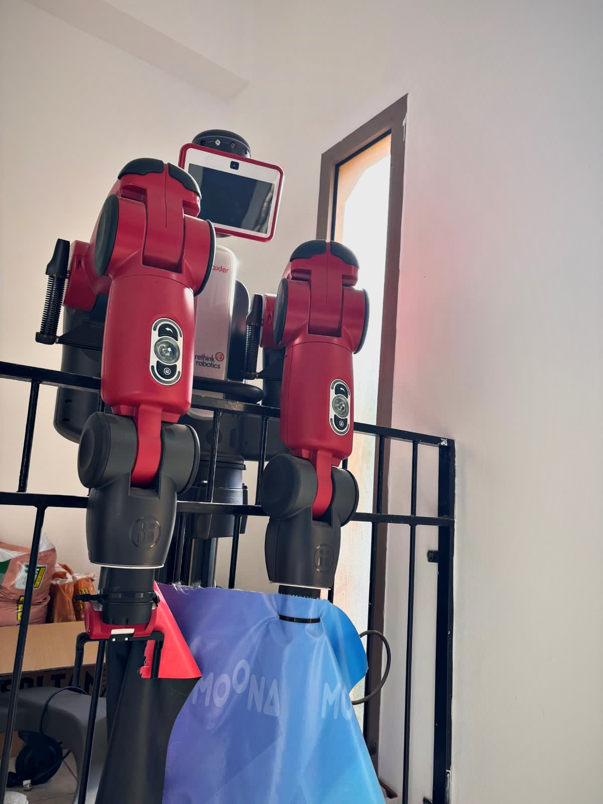 Red Baxter dual-arm robot in the lab